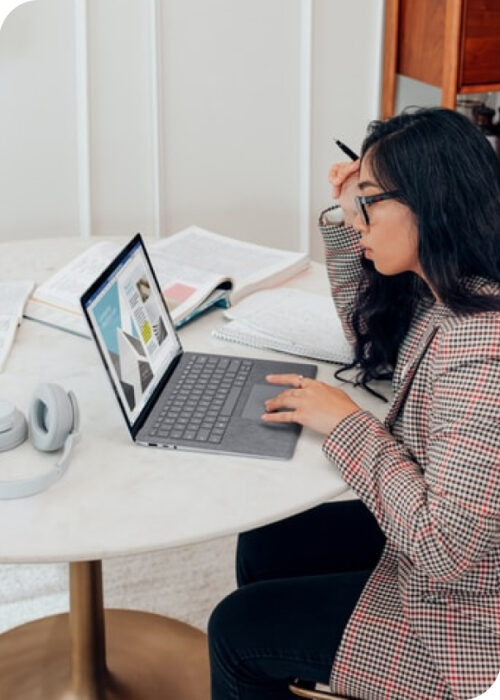 A women scratches her head while researching how to break into tech.