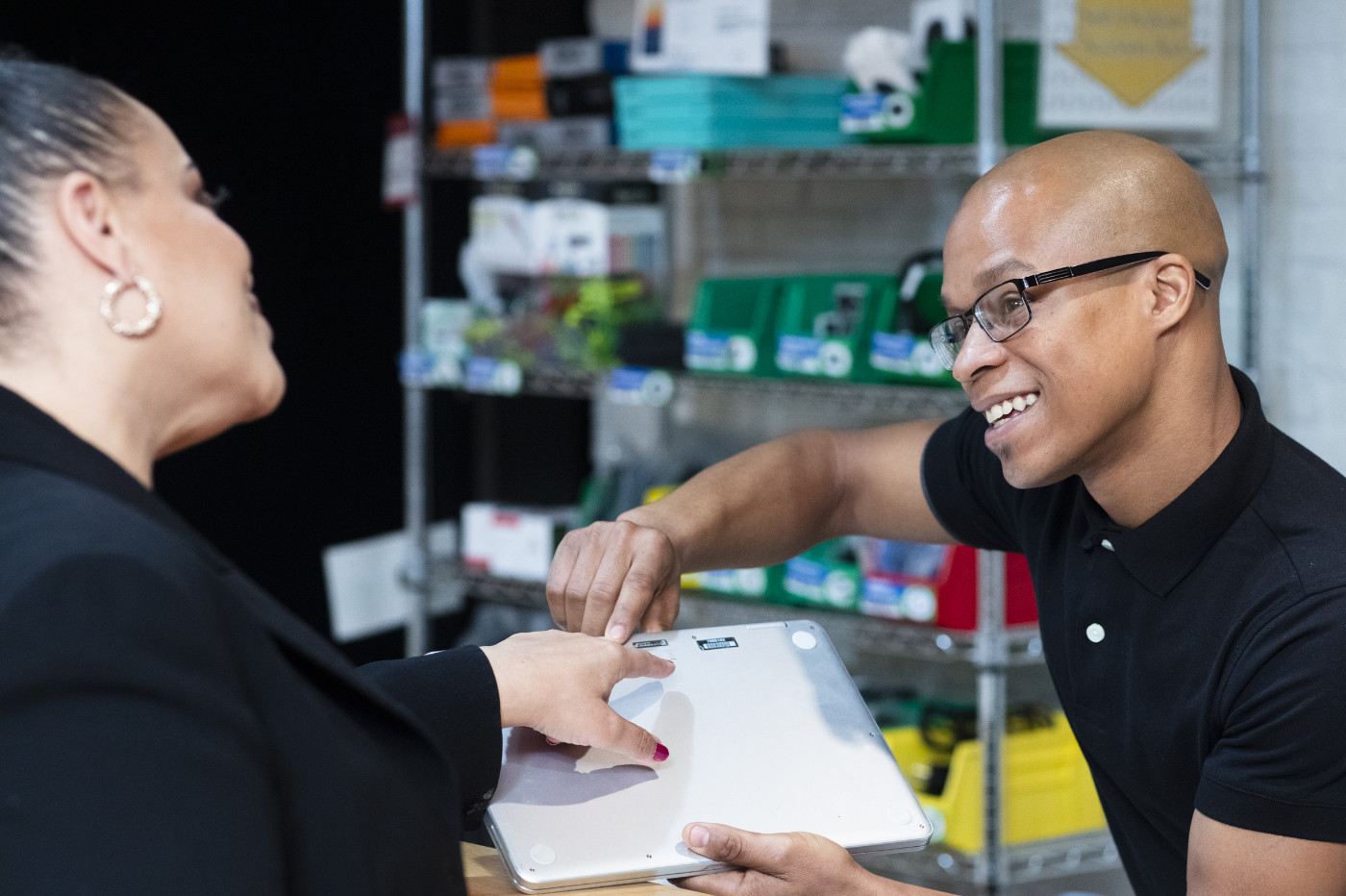 A Merit America alumnus talking with a colleague at work