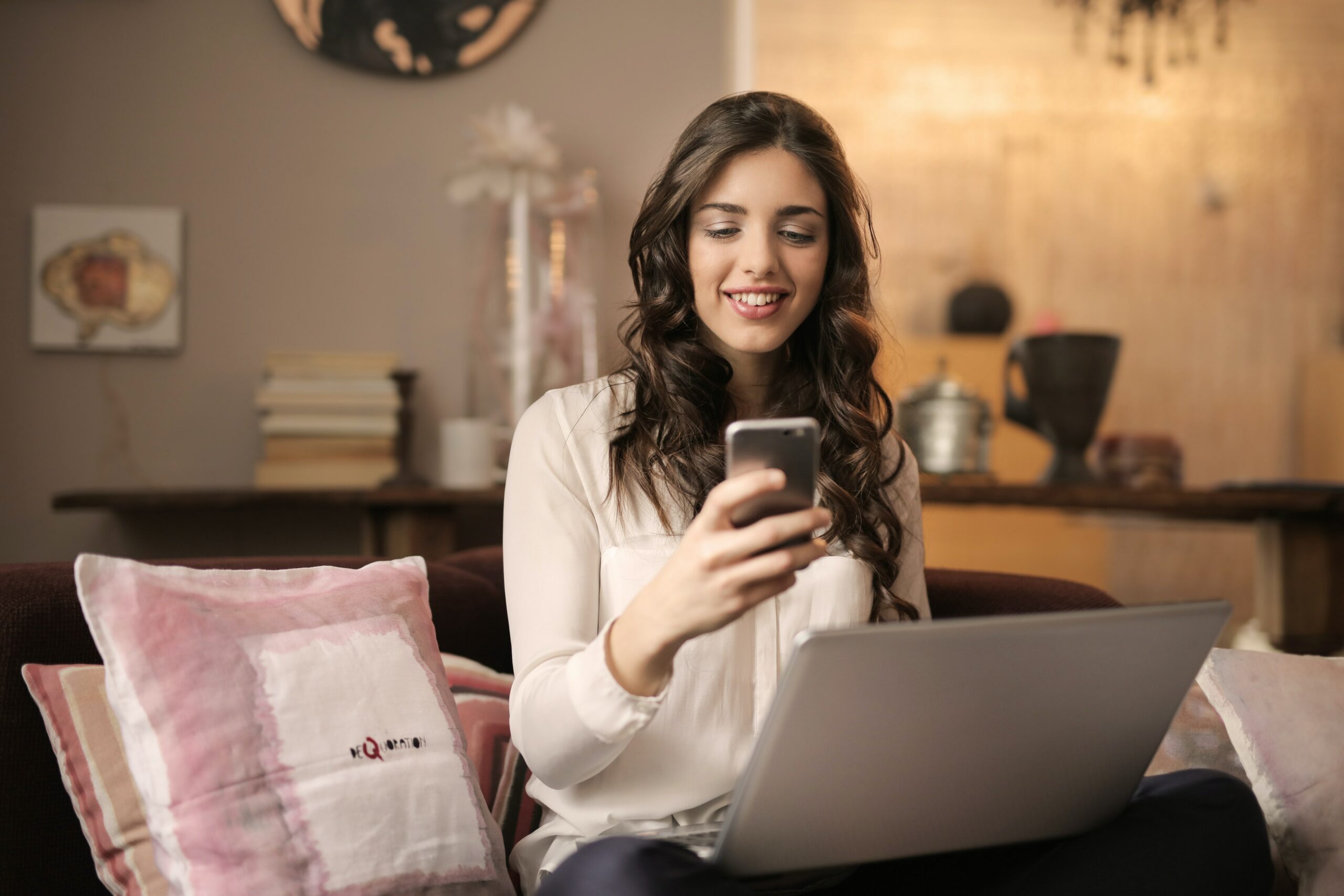 A woman looks at her phone and discovers Merit America's job training program.