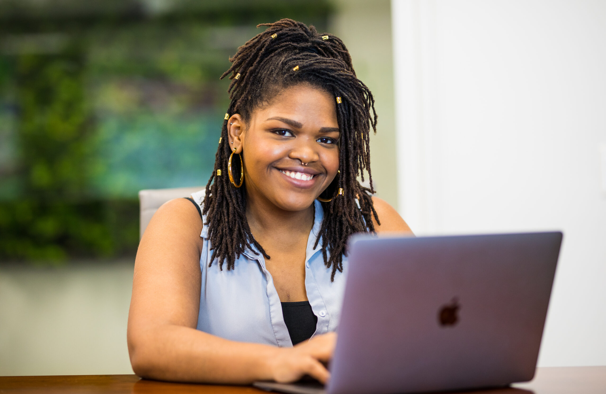 A Merit America alumni smiling during job training.