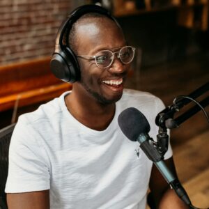 A man smiles during a podcast