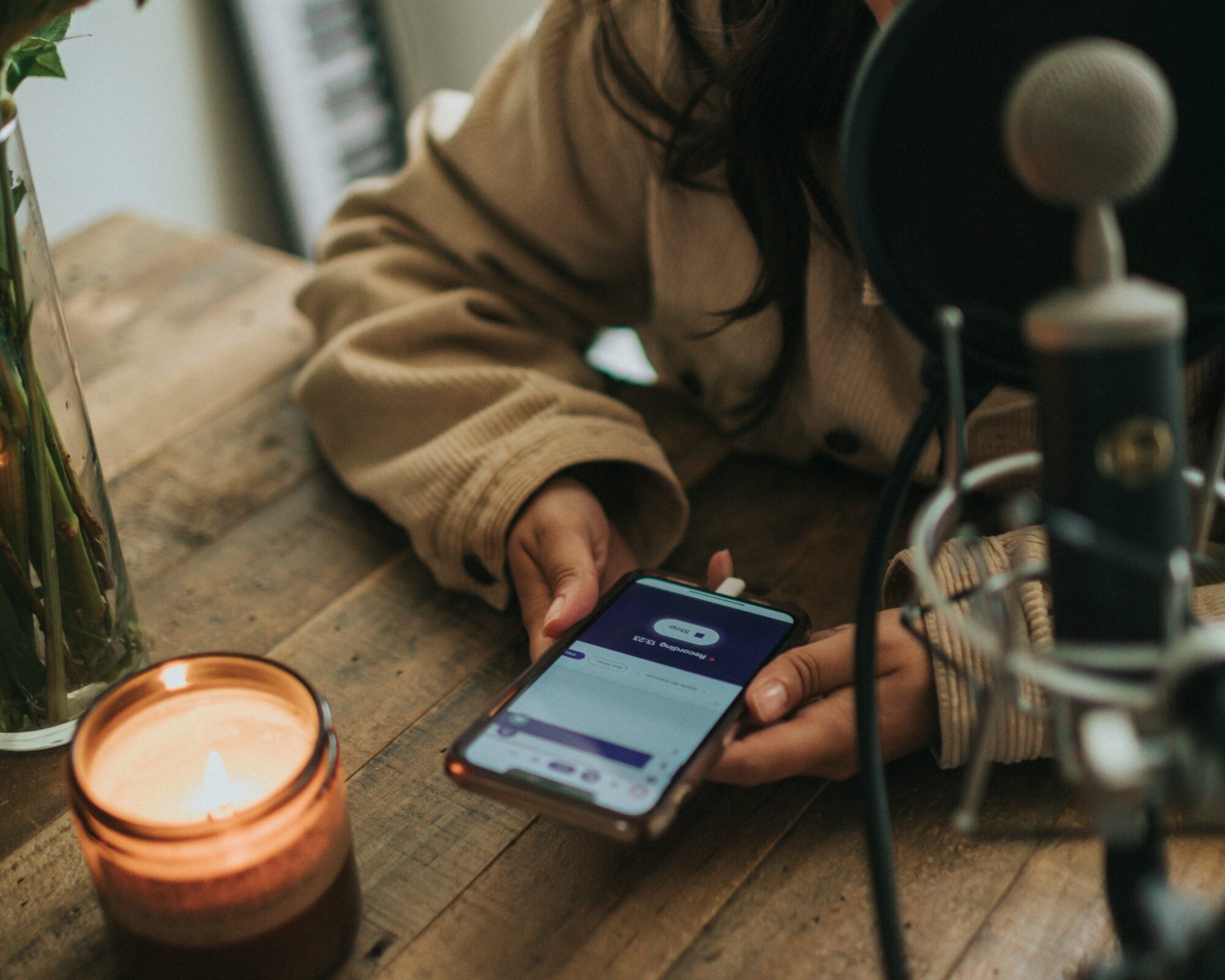 A woman smiles next to a phone