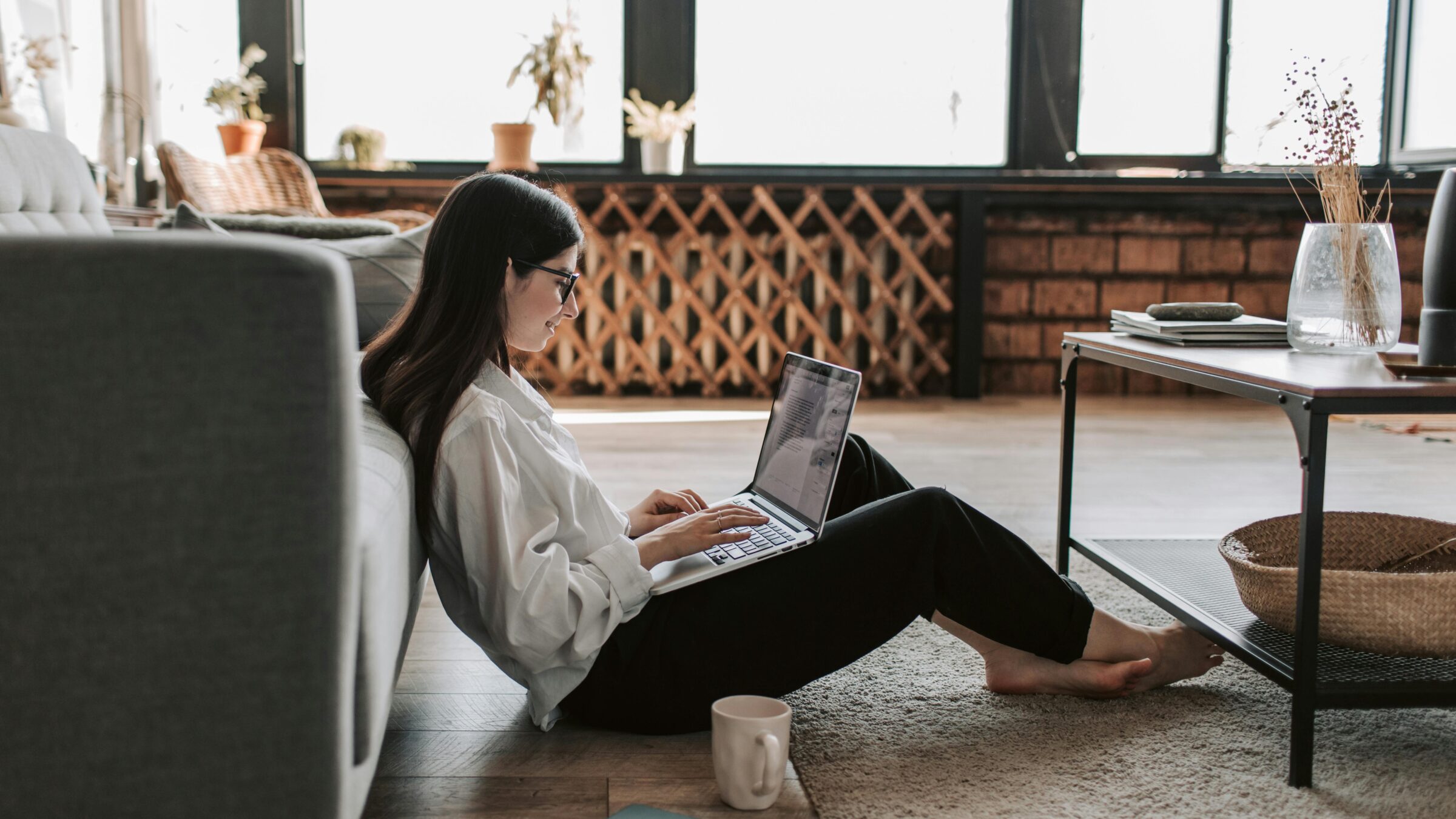 A woman working from home learning more about paying for Merit America.