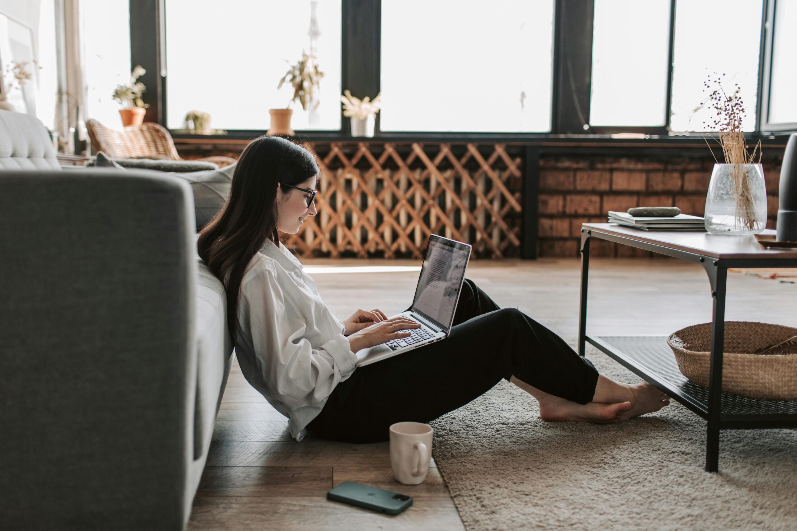 A woman working from home learning more about paying for Merit America.