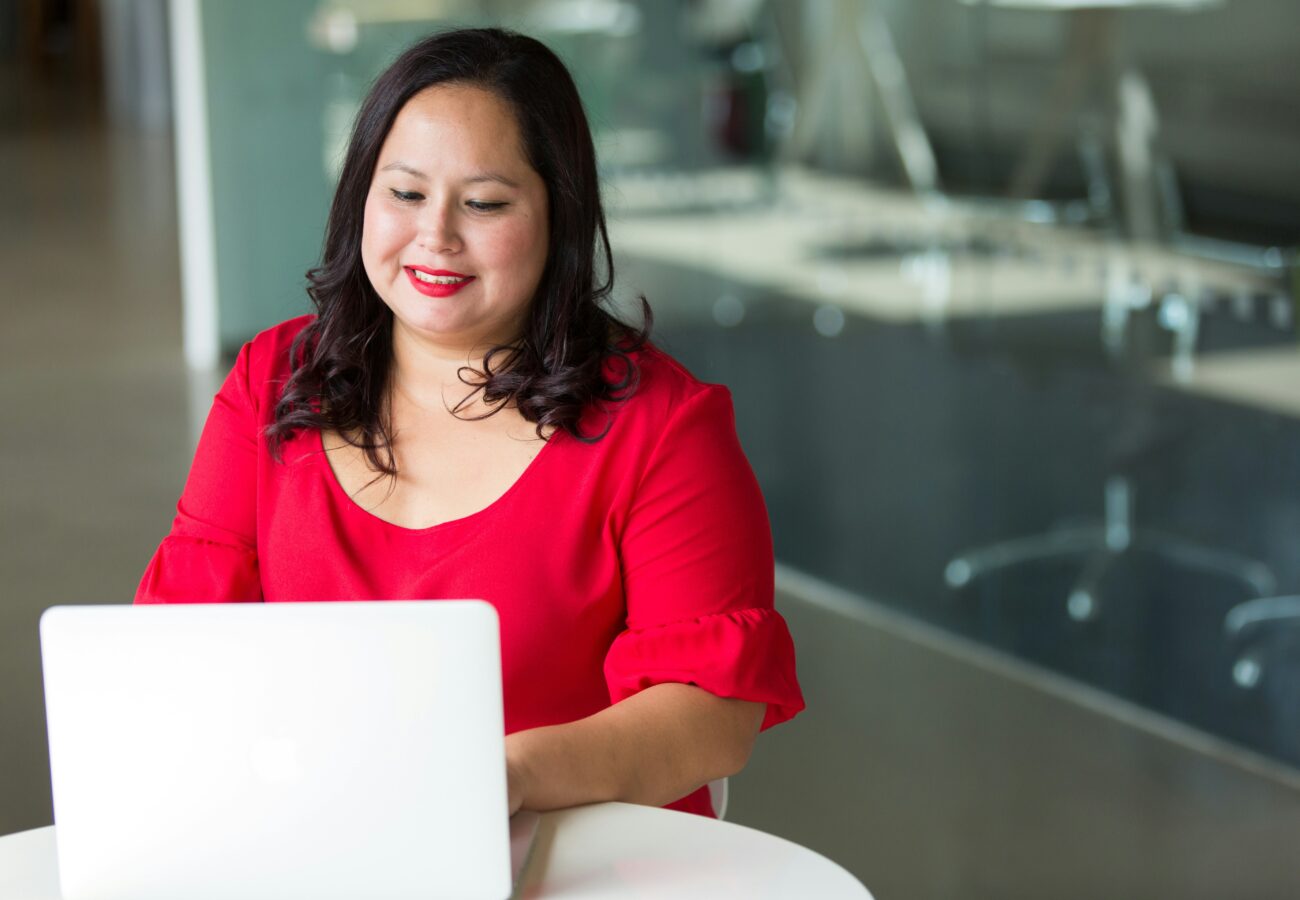 A woman looks at her computer.