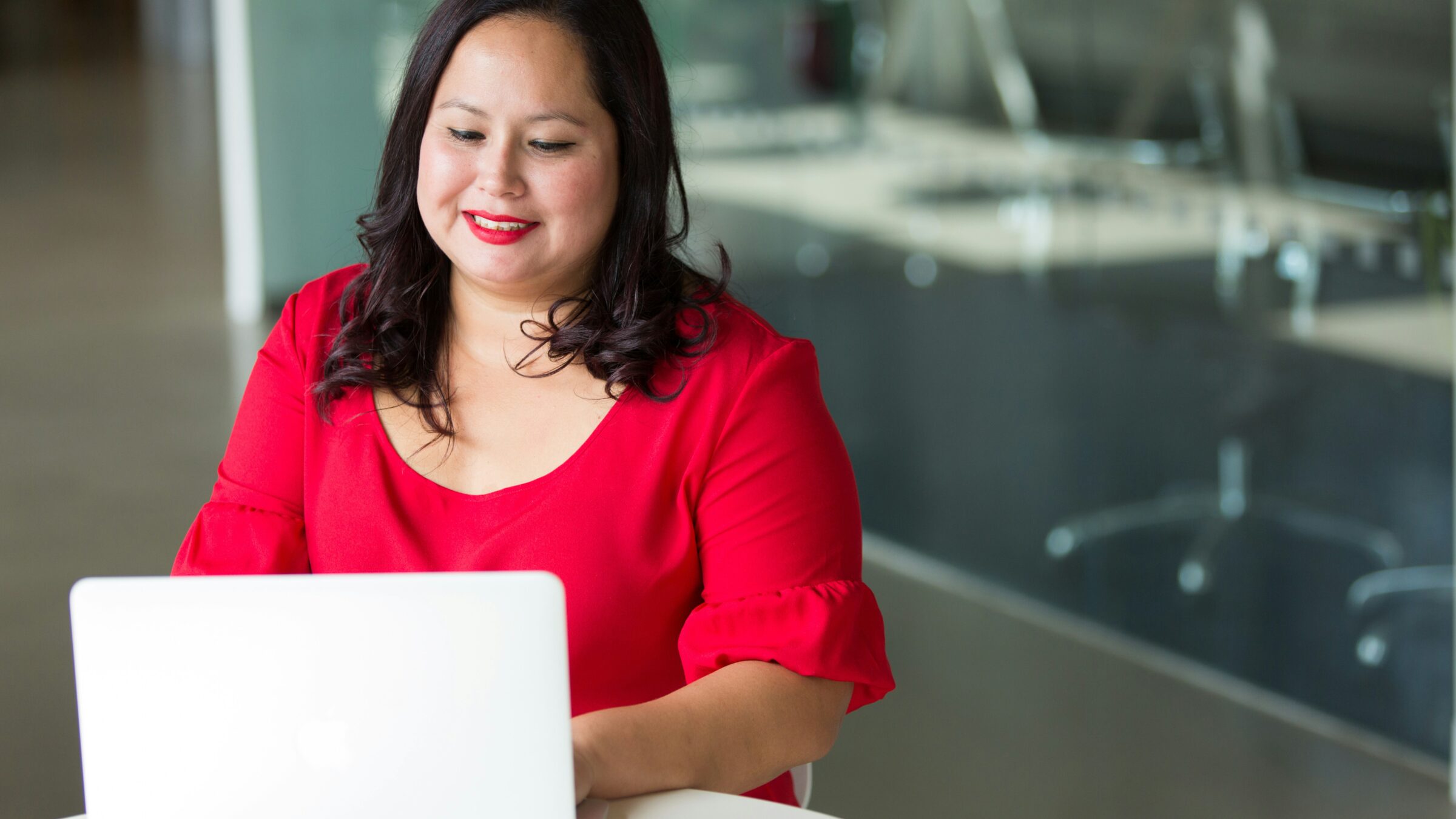 A learner works at her laptop.