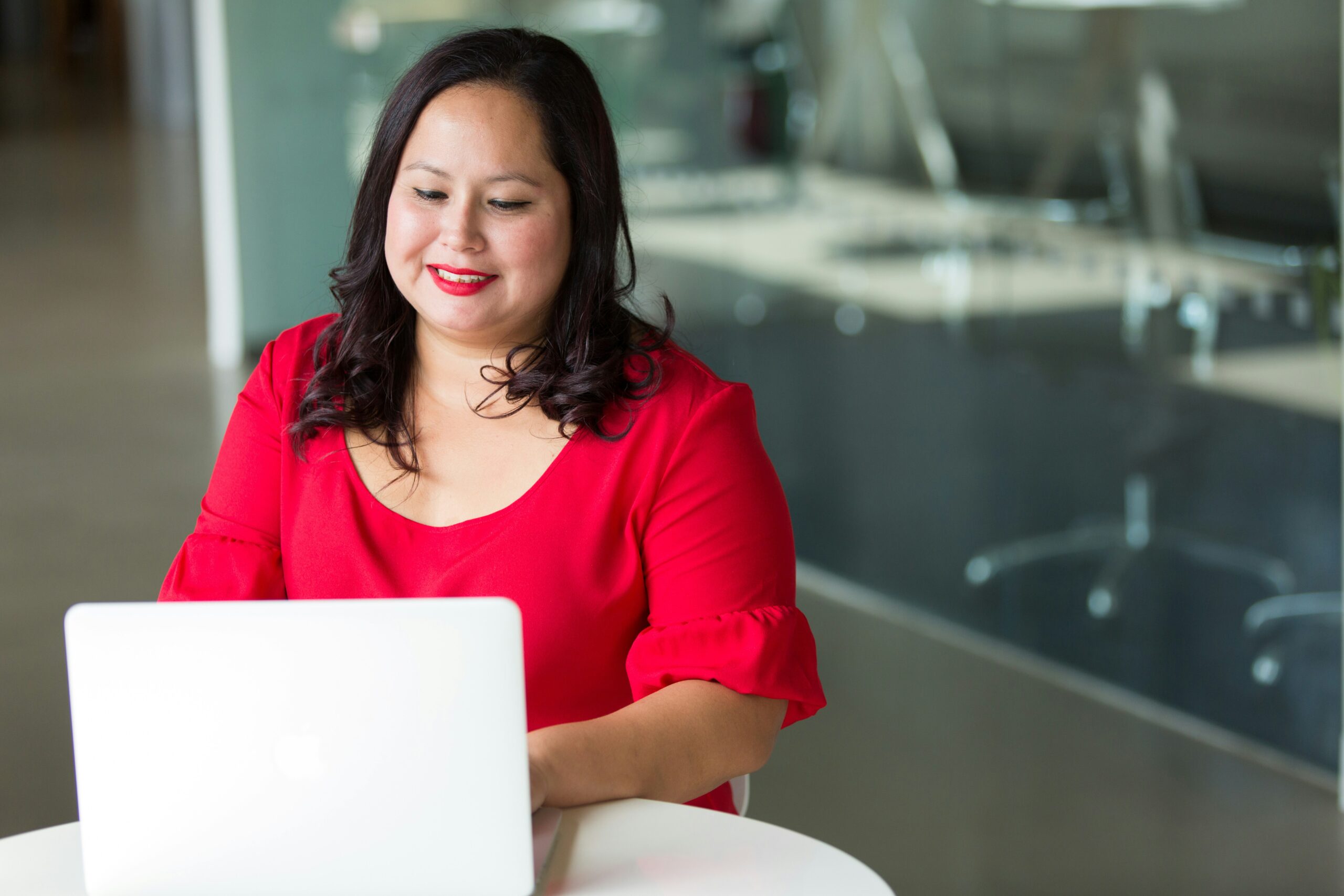 A learner works at her laptop.