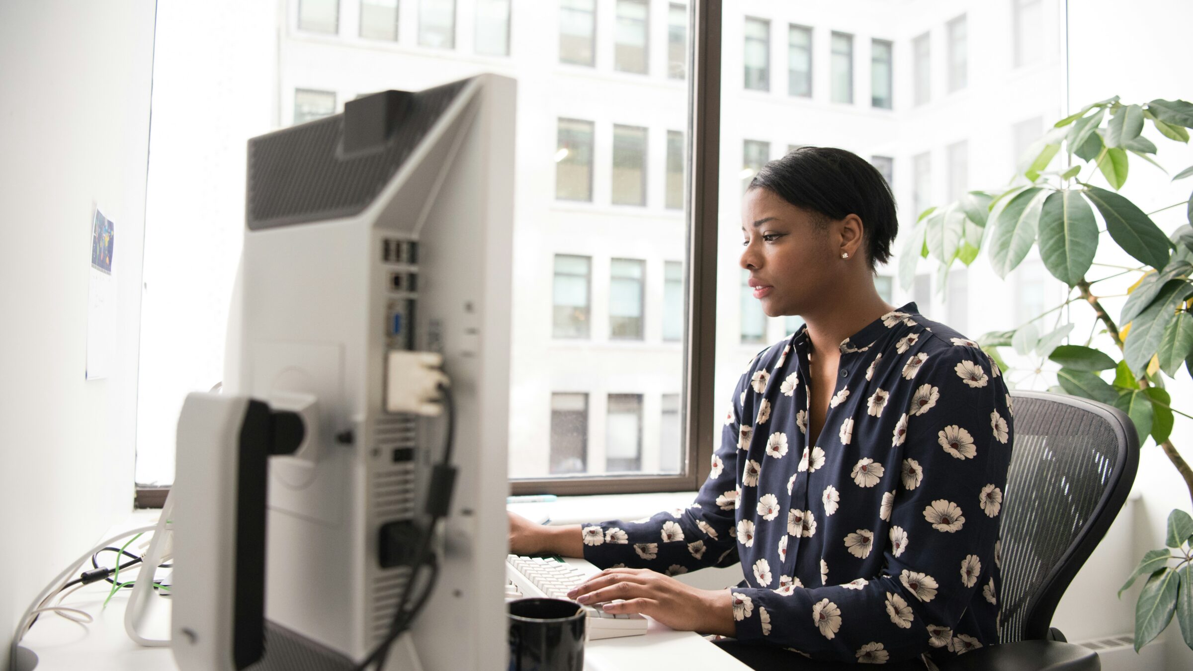 A woman looks at her computer.