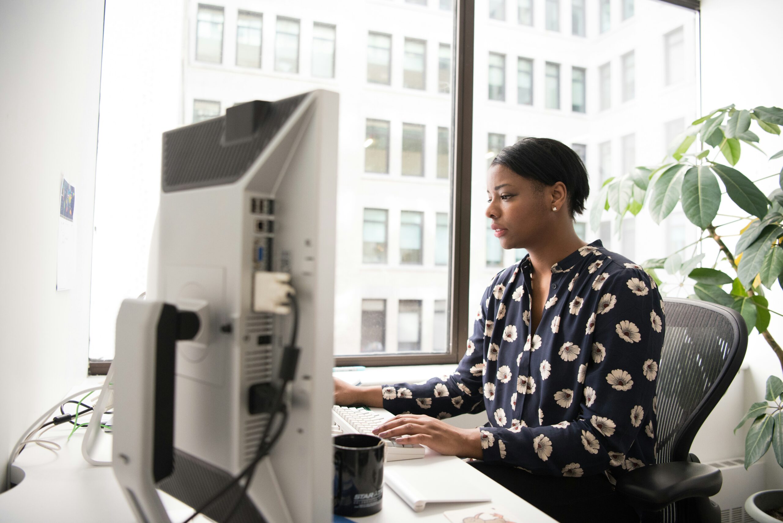A woman looks at her computer.