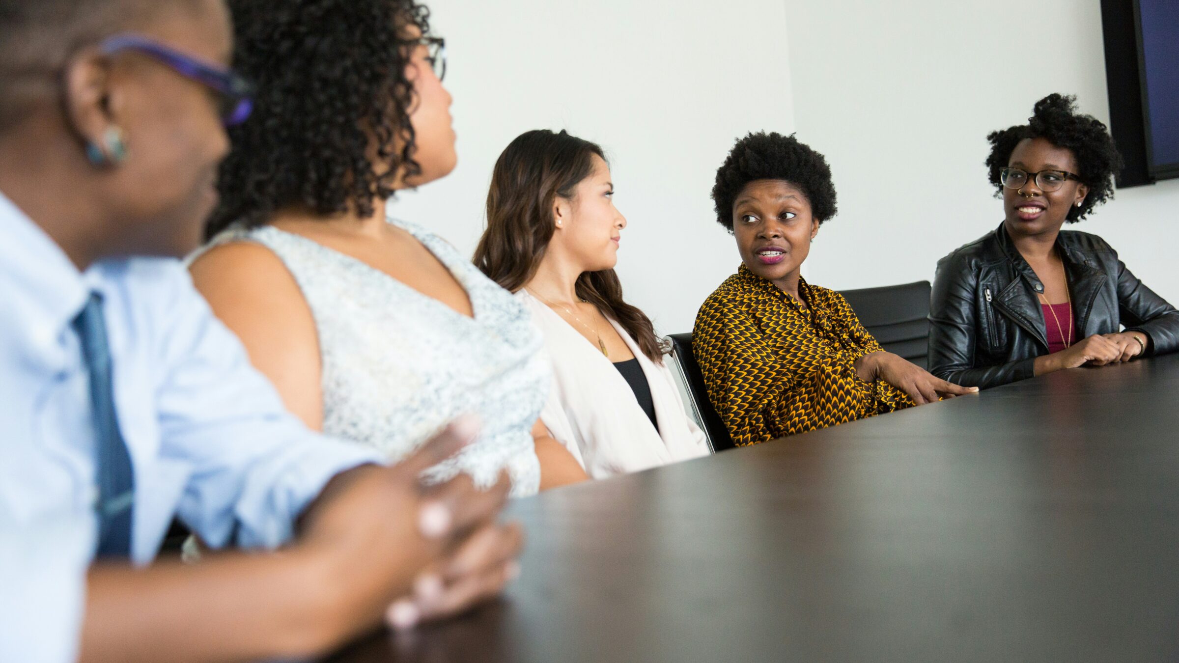 A table of learners discuss.