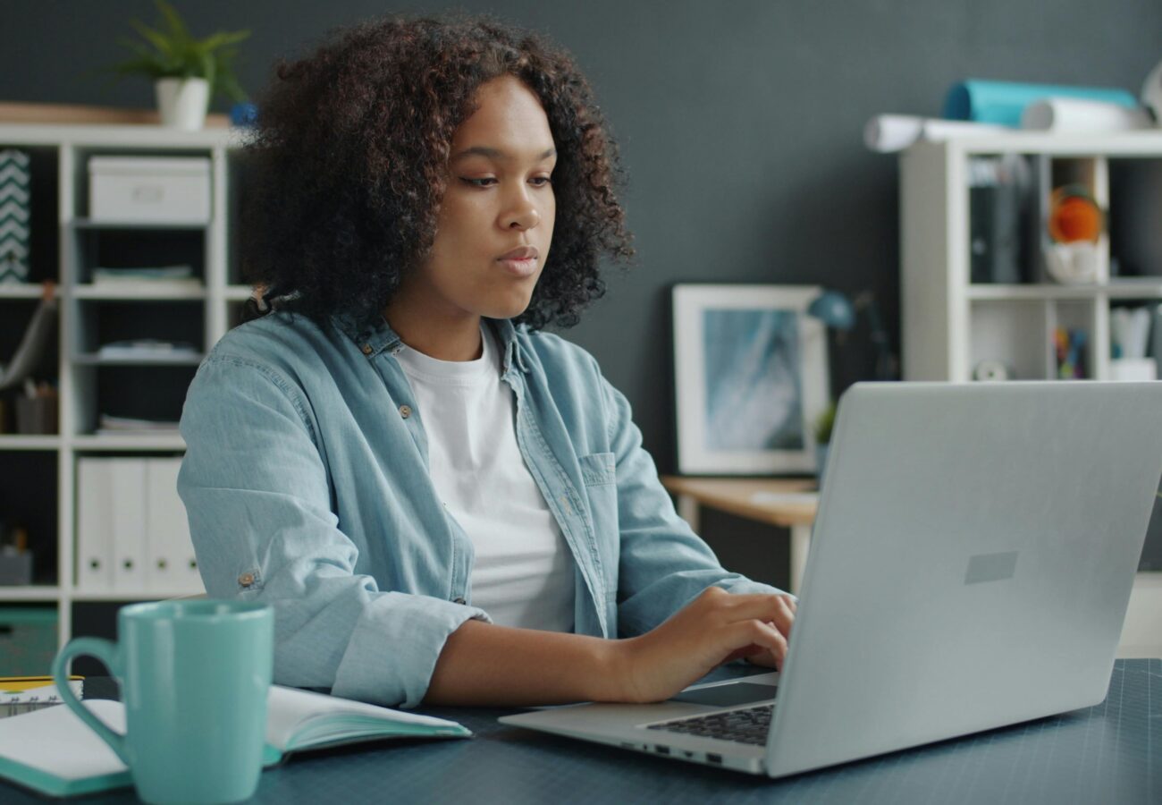 A woman looks at her computer